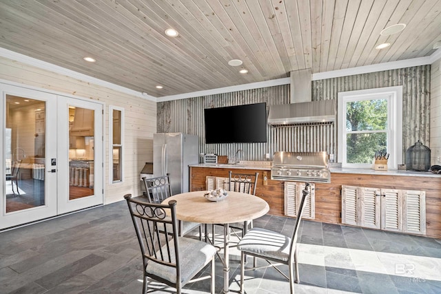 view of patio featuring outdoor dining area, area for grilling, a sink, a grill, and french doors