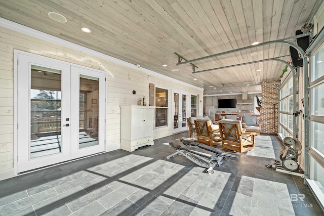 sunroom / solarium featuring wood ceiling and french doors