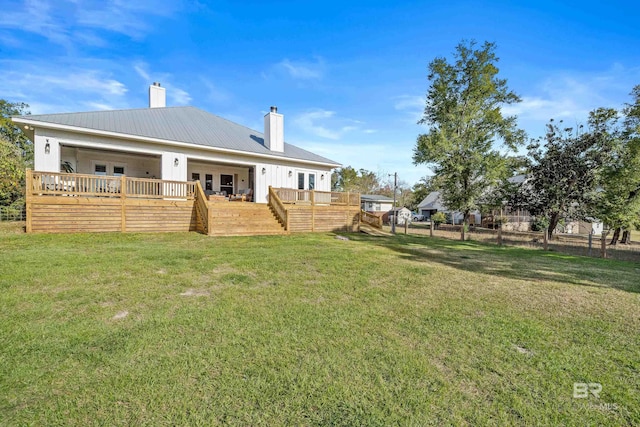 view of yard featuring french doors, fence, and a deck