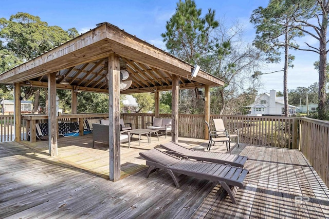 wooden terrace featuring outdoor lounge area and a gazebo