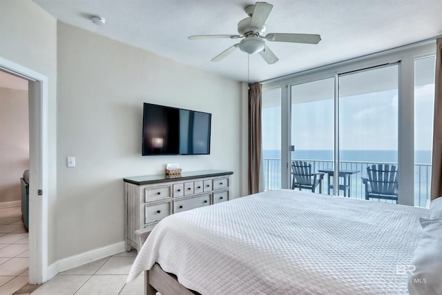 bedroom featuring access to exterior, ceiling fan, light tile patterned floors, and baseboards