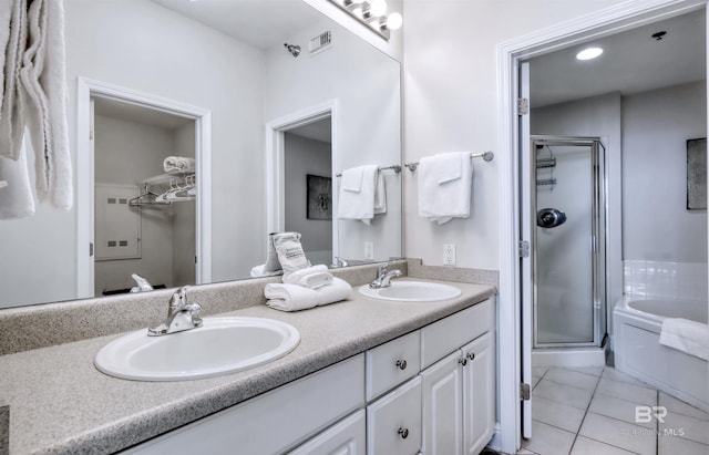 bathroom featuring tile patterned flooring, a sink, and a shower stall