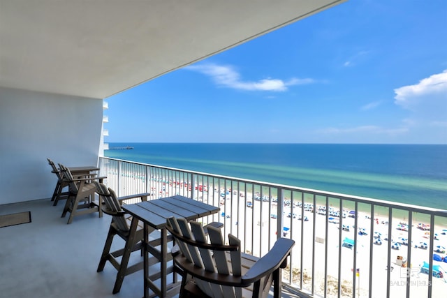 balcony featuring a water view and a beach view