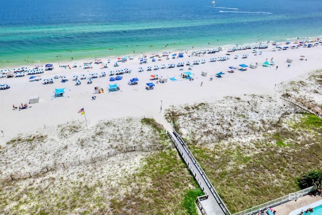 birds eye view of property with a water view and a beach view