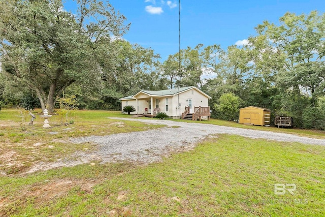 view of front of house featuring a front yard, a storage unit, and a deck