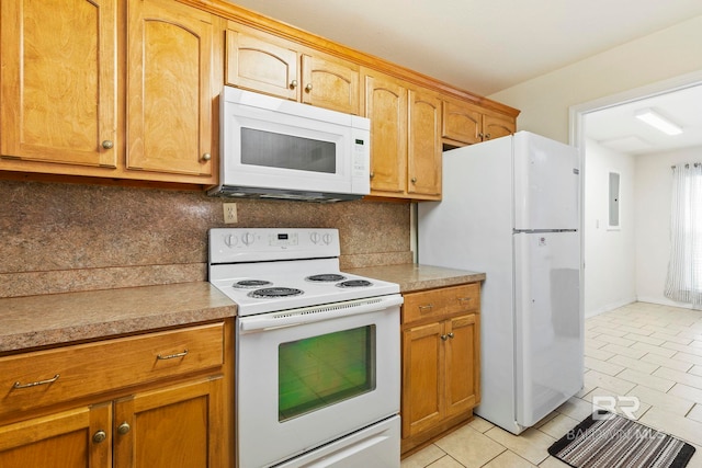 kitchen with white appliances, light tile patterned floors, and tasteful backsplash