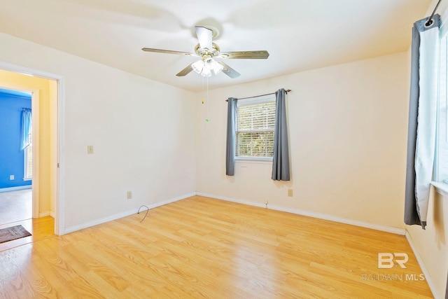 empty room with light wood-type flooring and ceiling fan