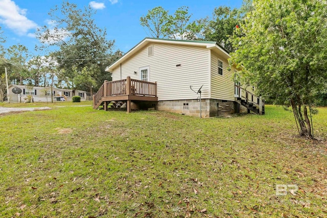 view of home's exterior featuring a deck and a yard