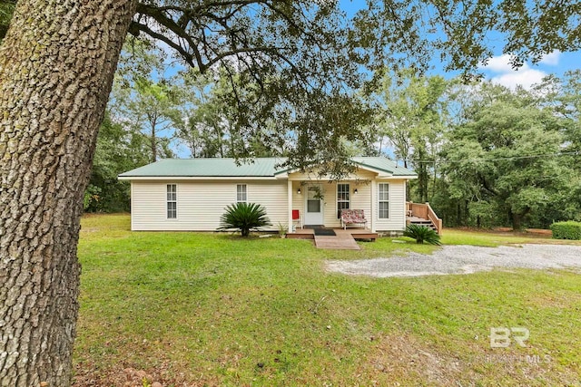 view of front of home with covered porch and a front yard