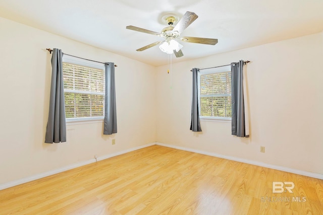 empty room featuring light hardwood / wood-style flooring, a healthy amount of sunlight, and ceiling fan