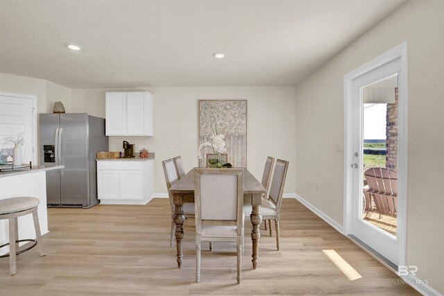 dining room featuring baseboards, light wood-type flooring, and recessed lighting