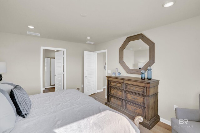 bedroom with baseboards, visible vents, recessed lighting, and wood finished floors