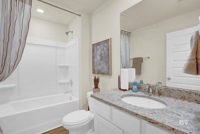 bathroom with shower / bath combo, toilet, and vanity