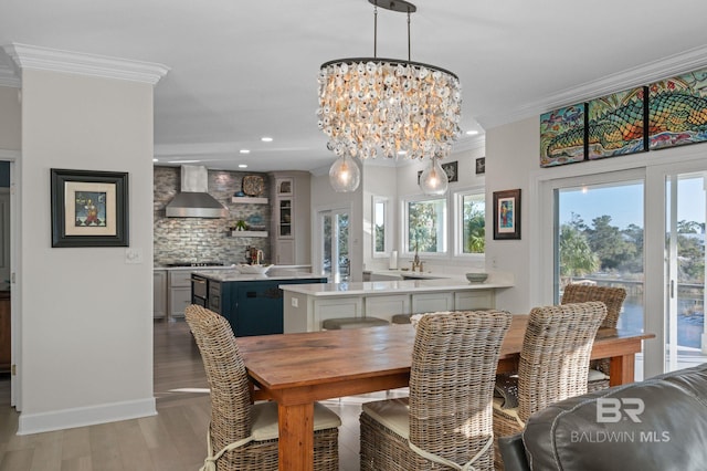 30471 Harbour Dr, Orange Beach, AL 36561 - dining space featuring baseboards, ornamental molding, recessed lighting, an inviting chandelier, and light wood-style floors