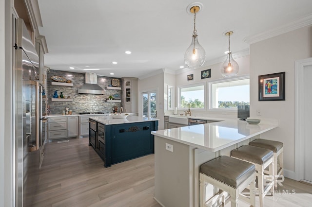 30471 Harbour Dr, Orange Beach, AL 36561 - kitchen featuring wall chimney range hood, stainless steel built in refrigerator, decorative backsplash, gas cooktop, and open shelves