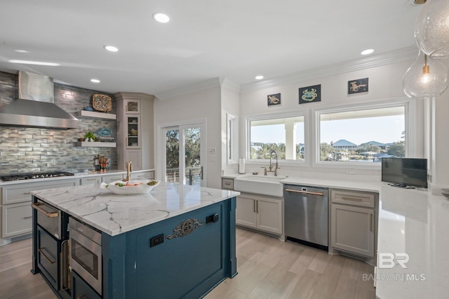 30471 Harbour Dr, Orange Beach, AL 36561 - kitchen with backsplash, crown molding, wall chimney range hood, appliances with stainless steel finishes, and a sink