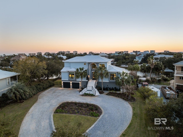 30471 Harbour Dr, Orange Beach, AL 36561 - view of front of property with stairway, an attached garage, and curved driveway