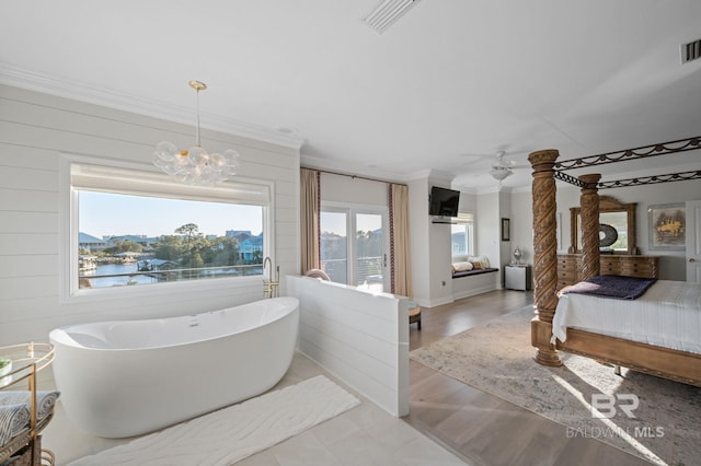 30471 Harbour Dr, Orange Beach, AL 36561 - full bathroom with a freestanding tub, wood finished floors, visible vents, and ornamental molding