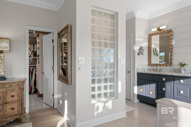 30471 Harbour Dr, Orange Beach, AL 36561 - full bathroom with vanity, a spacious closet, baseboards, and ornamental molding