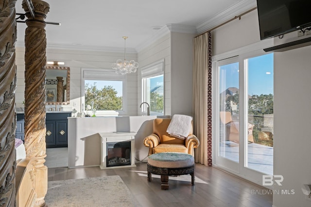 30471 Harbour Dr, Orange Beach, AL 36561 - living area with wood finished floors, an inviting chandelier, and ornamental molding