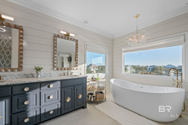 30471 Harbour Dr, Orange Beach, AL 36561 - full bathroom with crown molding, a chandelier, a freestanding bath, double vanity, and a sink