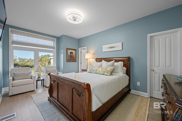 30471 Harbour Dr, Orange Beach, AL 36561 - bedroom featuring baseboards, visible vents, and light wood-type flooring