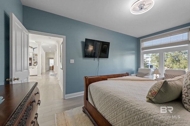 30471 Harbour Dr, Orange Beach, AL 36561 - bedroom with ornate columns, baseboards, and wood finished floors