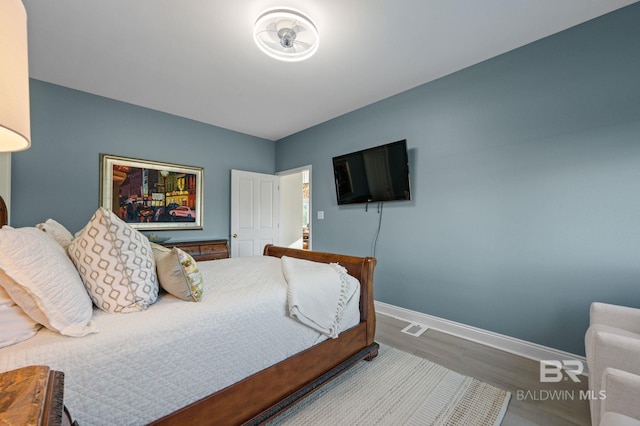 30471 Harbour Dr, Orange Beach, AL 36561 - bedroom with visible vents, wood finished floors, and baseboards