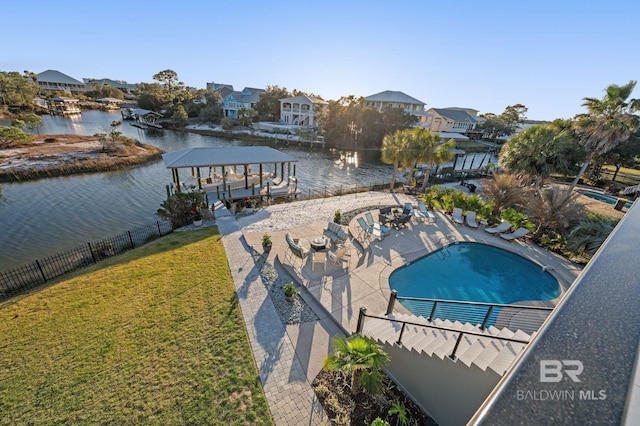 30471 Harbour Dr, Orange Beach, AL 36561 - community pool featuring a lawn, a water view, a patio, and fence