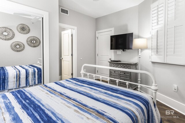 28105 Perdido Beach Blvd Unit C-314, Orange Beach, AL 36561 - bedroom featuring visible vents, baseboards, and wood finished floors