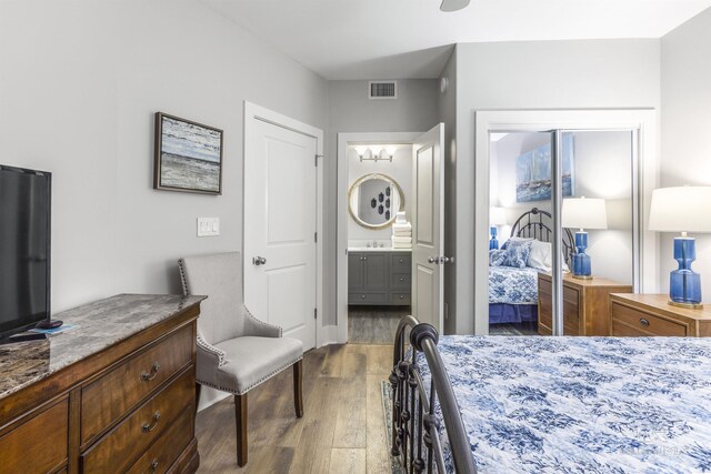 28105 Perdido Beach Blvd Unit C-314, Orange Beach, AL 36561 - bedroom with visible vents, ensuite bathroom, and wood finished floors