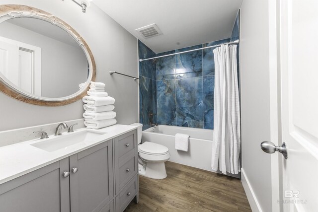 28105 Perdido Beach Blvd Unit C-314, Orange Beach, AL 36561 - full bathroom featuring vanity, toilet, shower / bath combination with curtain, wood finished floors, and visible vents