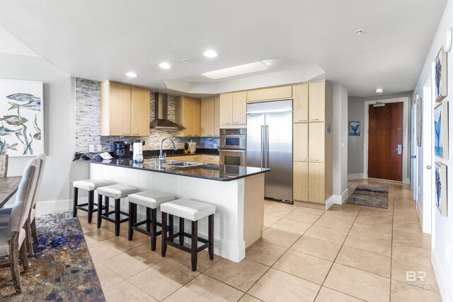 28105 Perdido Beach Blvd Unit C-314, Orange Beach, AL 36561 - kitchen featuring dark countertops, a sink, a raised ceiling, light brown cabinets, and stainless steel appliances