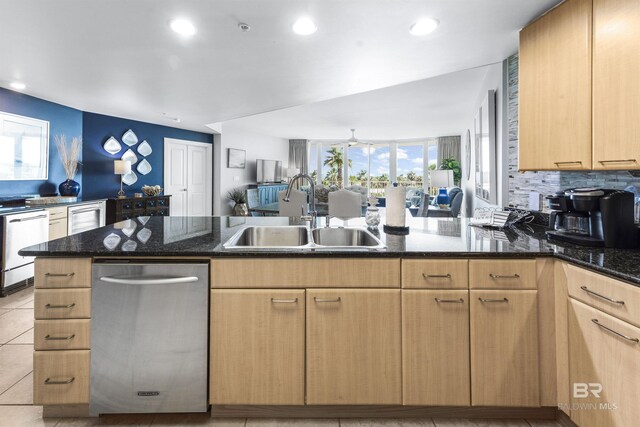 28105 Perdido Beach Blvd Unit C-314, Orange Beach, AL 36561 - kitchen with a sink, dark stone countertops, recessed lighting, open floor plan, and a peninsula