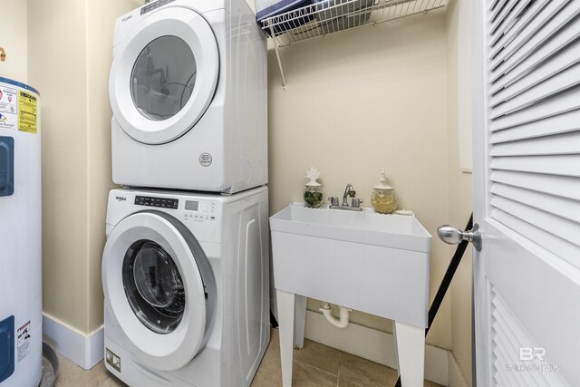 28105 Perdido Beach Blvd Unit C-314, Orange Beach, AL 36561 - laundry room with laundry area, stacked washer and dryer, a sink, water heater, and light tile patterned floors