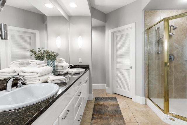 28105 Perdido Beach Blvd Unit C-314, Orange Beach, AL 36561 - full bathroom with a sink, baseboards, a stall shower, and double vanity