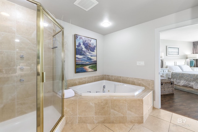 28105 Perdido Beach Blvd Unit C-314, Orange Beach, AL 36561 - ensuite bathroom featuring tile patterned floors, a shower stall, a jetted tub, and ensuite bath