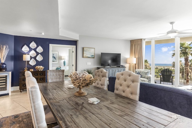 28105 Perdido Beach Blvd Unit C-314, Orange Beach, AL 36561 - dining space featuring ceiling fan, light tile patterned flooring, beverage cooler, and expansive windows