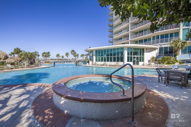 28105 Perdido Beach Blvd Unit C-314, Orange Beach, AL 36561 - pool featuring a community hot tub and a patio area