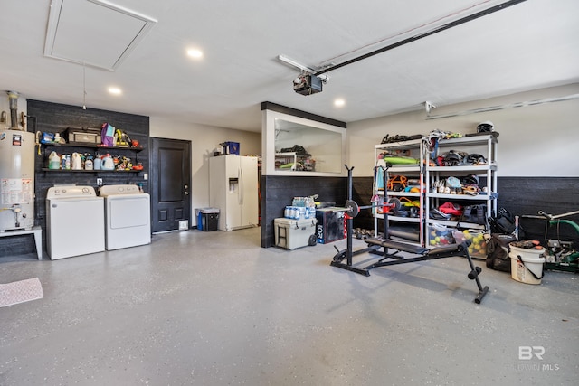 garage featuring washing machine and clothes dryer, a garage door opener, water heater, and white fridge with ice dispenser