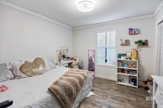 bedroom featuring wood-type flooring and ornamental molding