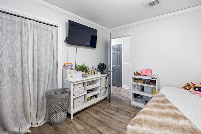 bedroom featuring dark hardwood / wood-style floors and crown molding