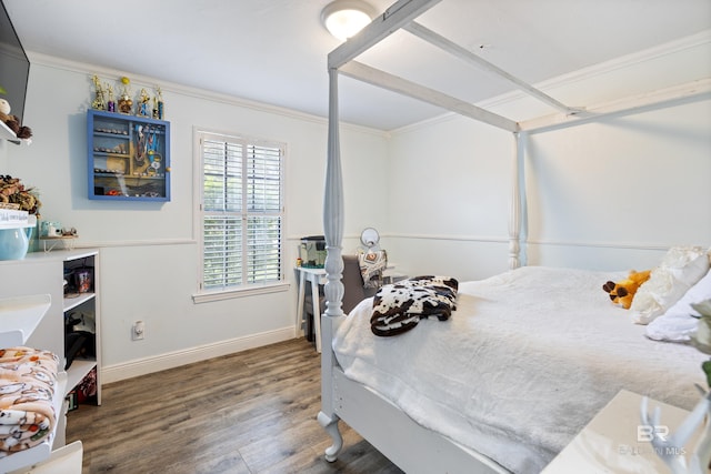 bedroom featuring dark hardwood / wood-style floors and ornamental molding