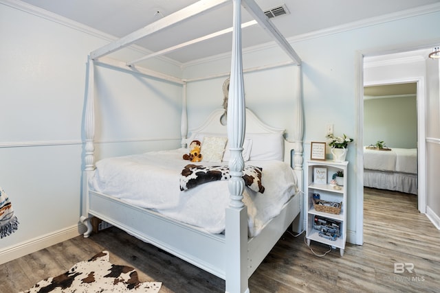 bedroom featuring hardwood / wood-style floors and ornamental molding