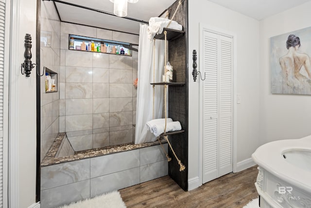 bathroom with hardwood / wood-style floors and a shower with curtain