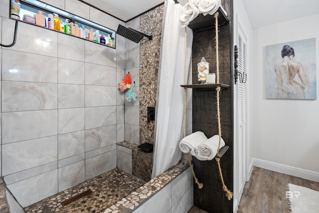 bathroom with a shower with shower curtain and hardwood / wood-style flooring