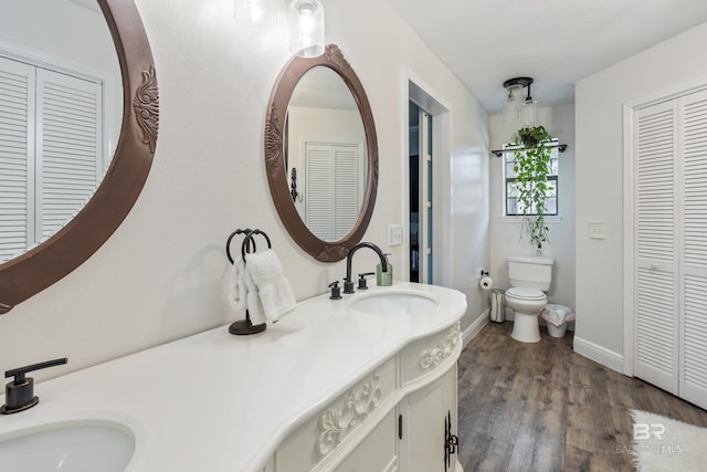 bathroom featuring hardwood / wood-style floors, vanity, and toilet