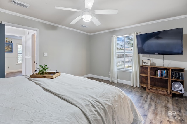 bedroom featuring ornamental molding, hardwood / wood-style flooring, and ceiling fan