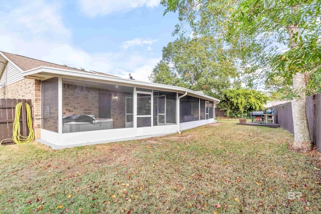 back of house featuring a sunroom and a yard