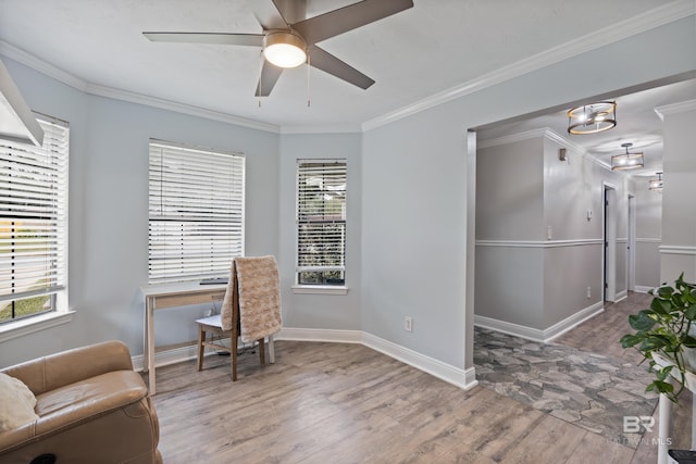 living area with hardwood / wood-style flooring, ceiling fan, crown molding, and a wealth of natural light